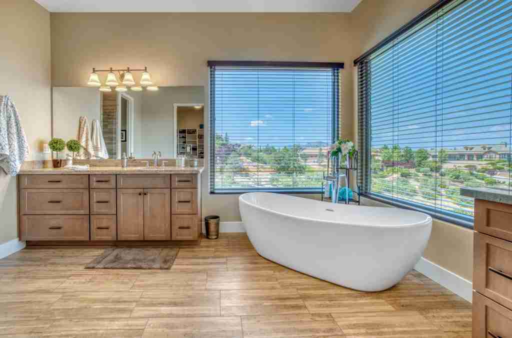 master bathroom with a tub and big windows Condo Bathroom Renovations in Toronto - 11