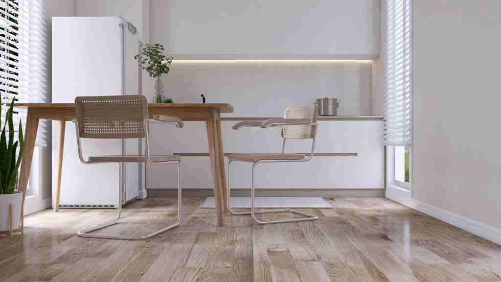 Modern, cozy white dining room with brown wooden table, chair, kitchen counter, cupboard, refrigerator, square tile splashback and window blinds on parquet floor for interior design background 3D Condo Flooring and Tiling in Toronto - 5