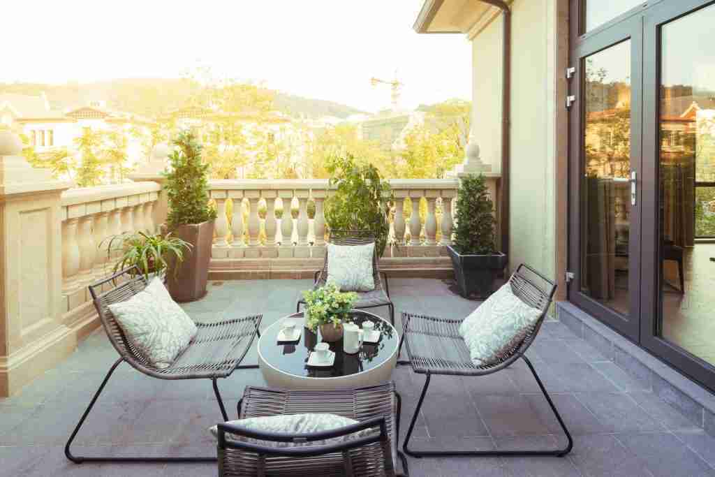 sunlight and table and chairs in modern balcony Condo Balcony and Terrace Renovation in Toronto - 3